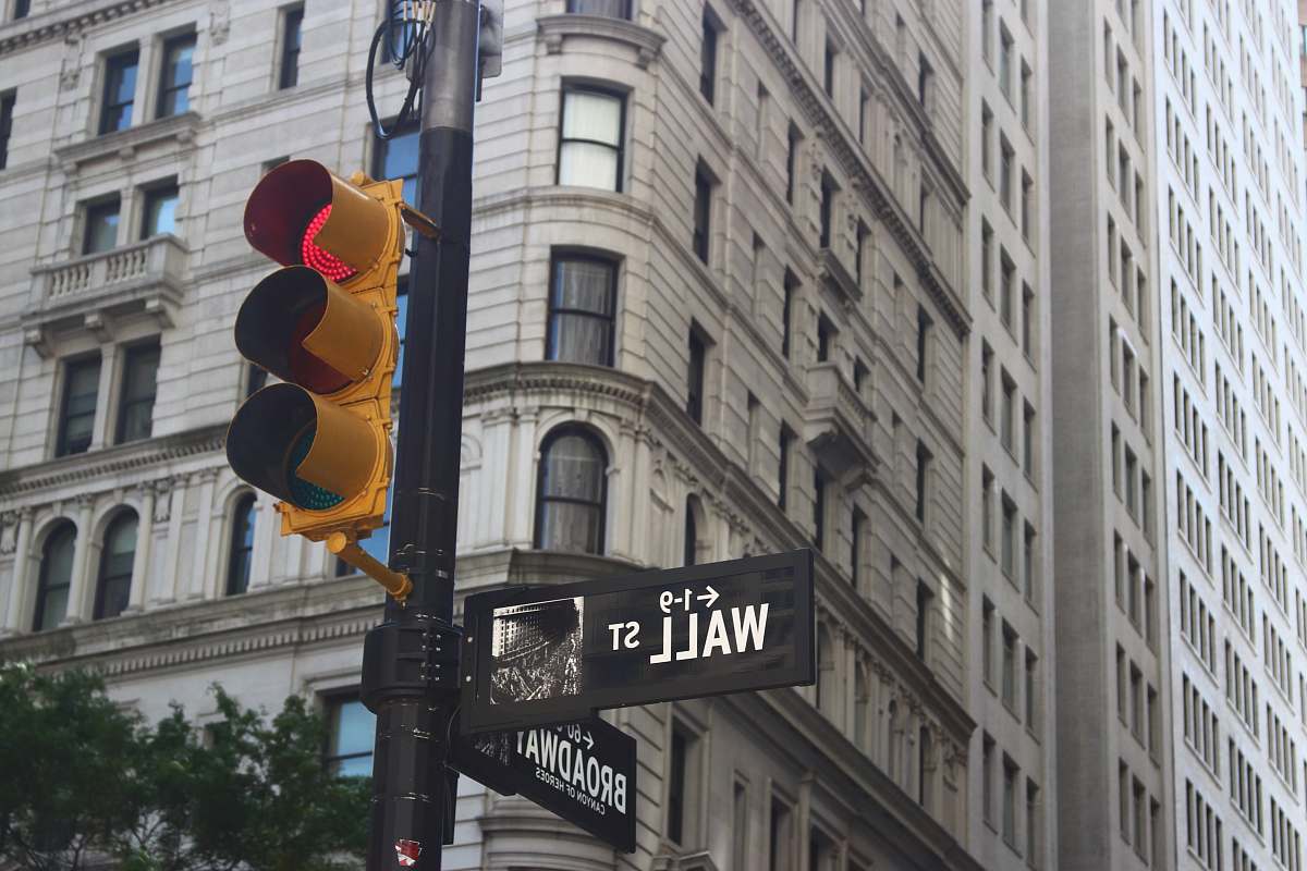 light traffic lights near white concrete building during day time wall street